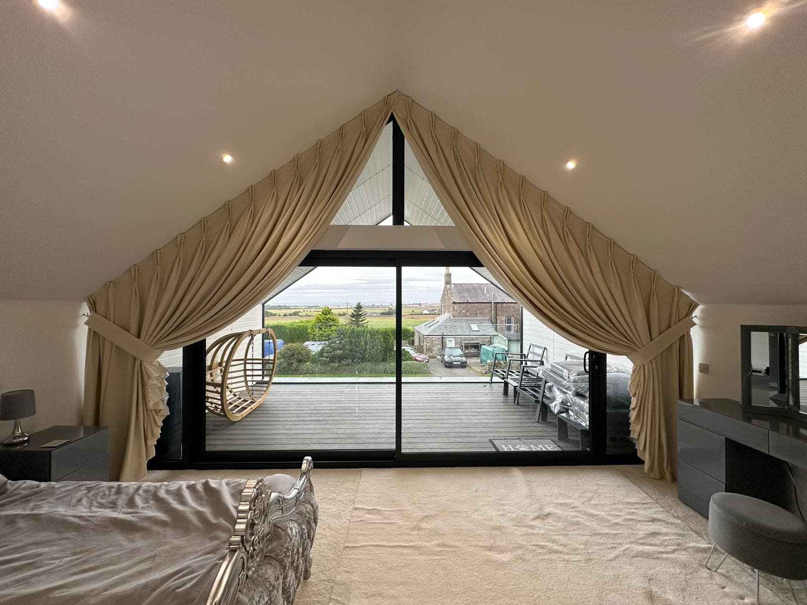 Oxford gable curtains gathered into matching tiebacks, with fabric remaining along the upper slopes